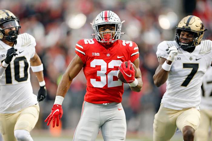 Ohio State Buckeyes running back TreVeyon Henderson (32) out runs Purdue Boilermakers safety Cam Allen (10) and Purdue Boilermakers cornerback Jamari Brown (7) to score a rushing touchdown against Purdue.